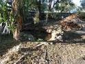 Backyard featuring stone features and natural foliage at 8526 Delaware Dr, Weeki Wachee, FL 34607