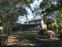 Expansive backyard with a screened-in porch and lush greenery at 8526 Delaware Dr, Weeki Wachee, FL 34607