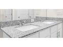Bright bathroom featuring a double sink vanity with granite countertops and modern fixtures at 8828 Mississippi Run, Weeki Wachee, FL 34613