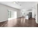 Open floor plan with hard floors and sliding glass doors, leading to the kitchen and dining area at 9062 Wade St, Brooksville, FL 34613