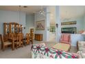 Open-concept living room featuring a dining area, comfortable seating, and high ceilings at 9405 Palm Haven Ct, New Port Richey, FL 34655