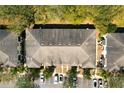 Bird's-eye view of townhome roofs and parking, displaying the community's layout and building structures at 10936 Keys Gate Dr, Riverview, FL 33579