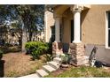 Inviting front entrance showcasing stone pillar bases and landscaped accents, enhancing the home's curb appeal at 10936 Keys Gate Dr, Riverview, FL 33579