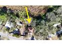 An aerial view of a single-Gathering house, surrounded by trees, is enhanced with an arrow at 12724 Circle Lake Dr, Hudson, FL 34669