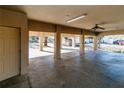 Large concrete carport on stilted home featuring ceiling fans, support beams, and lots of space at 12724 Circle Lake Dr, Hudson, FL 34669