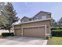 Two story home featuring an attached two car garage, neutral color scheme, and manicured landscaping at 13304 Mandalay Pl, Spring Hill, FL 34609