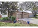Two story home featuring an attached two car garage and well maintained landscaping at 13304 Mandalay Pl, Spring Hill, FL 34609