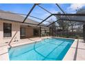 The screened-in pool area features a brick surround and ample space for entertaining next to the home's exterior patio at 1382 Aladdin Rd, Spring Hill, FL 34609