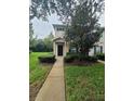 Home exterior with dark shutters and a small porch leading to the front door at 15772 Stable Run Dr, Spring Hill, FL 34610