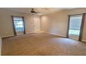 Spacious living room with natural light from the large windows at 15772 Stable Run Dr, Spring Hill, FL 34610
