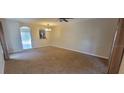 Open-concept living room featuring neutral walls, carpet and access to the kitchen at 15772 Stable Run Dr, Spring Hill, FL 34610