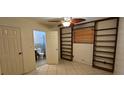 Bedroom with tile flooring, shelving, and an ensuite bathroom at 17932 Wendy Sue Ave, Hudson, FL 34667
