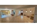 Open living room with tile flooring, chandelier lighting, and backyard access at 17932 Wendy Sue Ave, Hudson, FL 34667