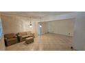 Living room with tile floors and sliding glass doors to outdoor area at 17932 Wendy Sue Ave, Hudson, FL 34667