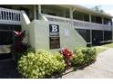 Well-manicured condo complex featuring a smoke-free community and vibrant foliage at 20857 Haulover Cv # B15, Lutz, FL 33558
