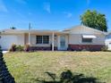 Charming single-story home with a well-maintained lawn and tidy landscaping at 3243 Bayport Dr, Holiday, FL 34691