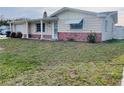 Charming single-story home with a well-maintained lawn and tidy landscaping at 3243 Bayport Dr, Holiday, FL 34691