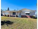 Charming single-story home with a well-maintained lawn and tidy landscaping at 3243 Bayport Dr, Holiday, FL 34691