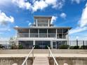 Rear view of house, with a large screened porch and railings leading to the waterfront at 3344 Gardenia Dr, Hernando Beach, FL 34607