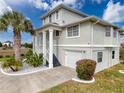 Charming home featuring lush landscaping, white columns, and a welcoming facade at 3344 Gardenia Dr, Hernando Beach, FL 34607