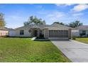 Well-maintained single Gathering home with a concrete driveway and two-car garage at 3484 Tomahawk Ave, Spring Hill, FL 34606