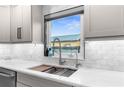 Kitchen sink featuring stainless steel faucet, white countertops, subway tile backsplash, and new window at 4144 Glade Rd, Spring Hill, FL 34606