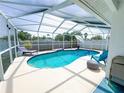 Inviting screened-in pool with blue lounge chairs and privacy fence at 5801 65Th N Ter, Pinellas Park, FL 33781