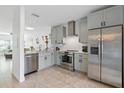 Bright kitchen features stainless steel appliances, light gray cabinets, and granite countertops at 6027 Bayside Key Dr, Tampa, FL 33615