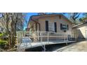Exterior view of the house showcasing an access ramp and complementing the home's architecture at 6825 Main St, New Port Richey, FL 34653