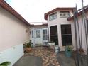 Inviting entrance with unique stained glass windows and tiled walkway at 7308 Mako Dr, Hudson, FL 34667