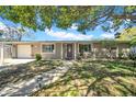 Inviting single-story home featuring a well-maintained lawn and attached garage at 7353 Banner St, New Port Richey, FL 34653
