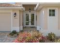 Elegant double-door entrance with beautiful landscaping, accentuating the home's curb appeal at 8910 Jericho Rd, Weeki Wachee, FL 34613