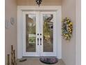 Inviting double door entry featuring glass panels and stylish decor for an enhanced welcome at 8910 Jericho Rd, Weeki Wachee, FL 34613