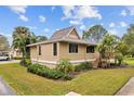 Exterior showcases mature landscaping, complemented by well-manicured lawns and ample greenery at 1002 Caravel Ct, Tarpon Springs, FL 34689