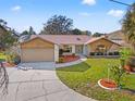 Well maintained single Gathering home with beautiful landscaping and a long driveway at 1011 Altoona Ave, Spring Hill, FL 34609