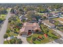 Stunning aerial view of a single-story home with mature landscaping and a circular driveway at 1011 Altoona Ave, Spring Hill, FL 34609