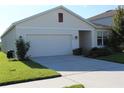 A front-facing view of a single-Gathering home featuring an attached two-car garage and concrete driveway at 10188 Cross Timber Ter, Land O Lakes, FL 34638