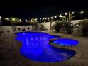 Beautiful pool and spa area with brick pavers and relaxing lounge chairs at night at 11611 Lake Blvd, New Port Richey, FL 34655