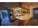 Kitchen with wood cabinets and a stainless steel refrigerator at 13140 Moon Rd, Brooksville, FL 34613