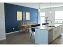 Open dining area next to kitchen with stylish pendant lights and accent wall at 15384 Caravan Ave, Odessa, FL 33556