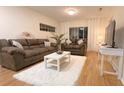 Cozy living room features two couches, white rug and table, and a mounted TV at 19325 Water Oak Dr # 205, Port Charlotte, FL 33948