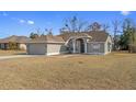 Traditional single Gathering home with neutral paint, attached garage, and simple landscaping at 2124 Godfrey Ave, Spring Hill, FL 34609