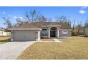 Charming single Gathering home with neutral paint, attached garage, and traditional landscaping at 2124 Godfrey Ave, Spring Hill, FL 34609