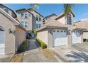 Charming townhome showcasing a two-car garage, well-maintained landscaping, and inviting curb appeal at 2764 Countryside Blvd # 3, Clearwater, FL 33761