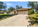 Exterior shot of home with an attached two-car garage and a concrete driveway at 3273 Bluestone Ave, Spring Hill, FL 34609