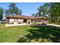 A lovely one-story home with beautiful landscaping, a manicured lawn, and a two-car garage at 3273 Bluestone Ave, Spring Hill, FL 34609