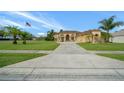 Charming, single story home with desert landscaping, concrete driveway, and visible American flag at 3542 Conifer Loop, Spring Hill, FL 34609