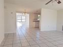 Open living space with tile flooring, seamlessly connecting to the dining area and kitchen at 7421 San Miguel Dr, Port Richey, FL 34668