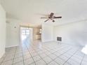 Spacious living room with tile floors, ceiling fan, and an open layout at 7421 San Miguel Dr, Port Richey, FL 34668