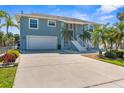 Two-story home with a spacious driveway, two car garage, and beautiful landscaping at 8408 Damen Ln, Port Richey, FL 34668